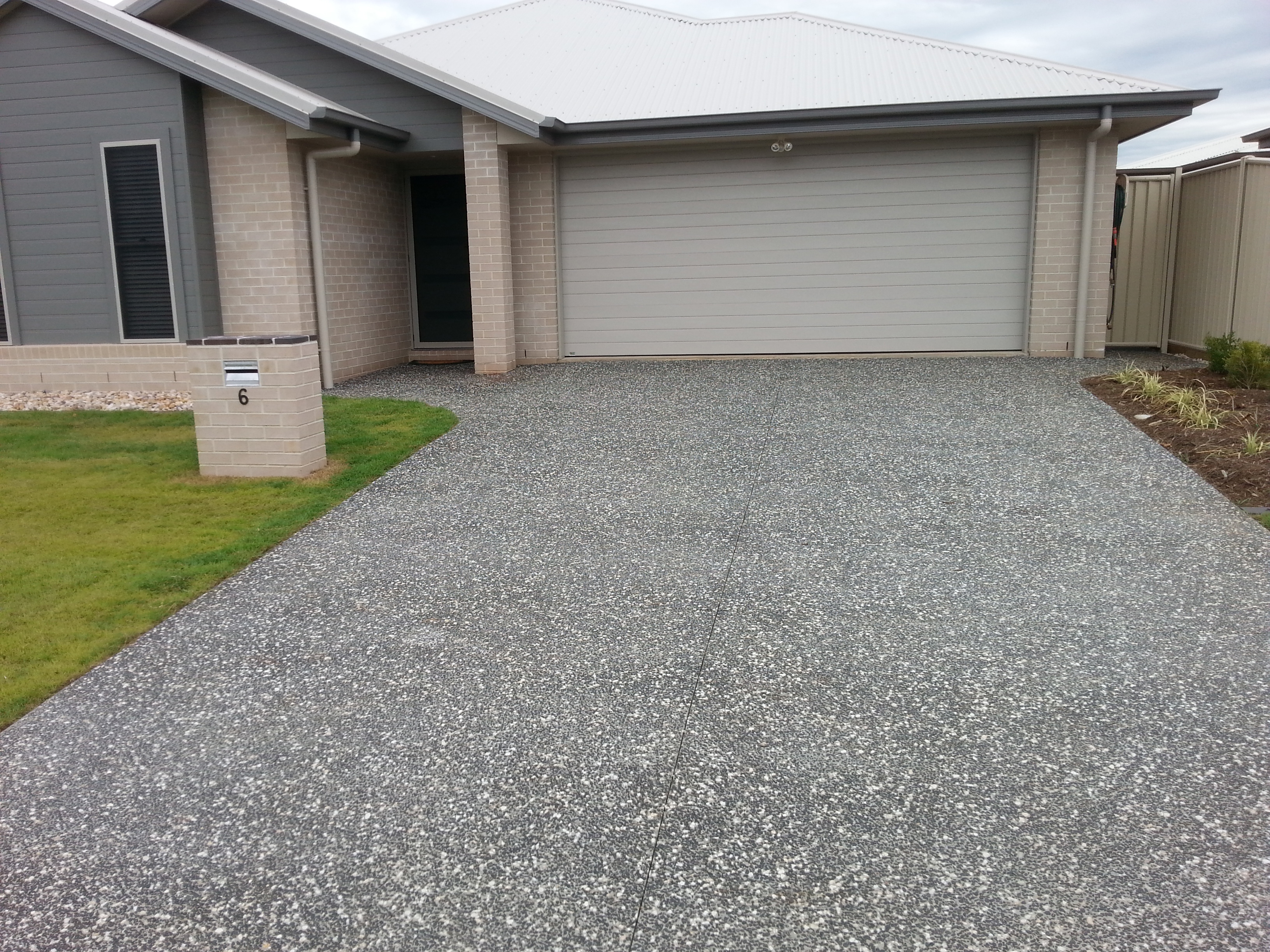 This driveway has been sealed with the Dulux Avista Exposed Aggregate Concrete Sealer.