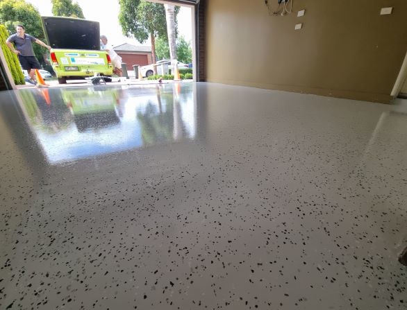 A garage floor updated with Dulux Avista Decorative Flakes by McGlashan Painting.